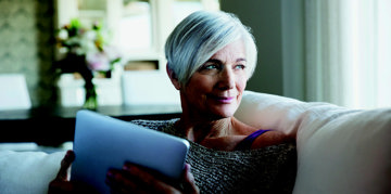 Elderly woman using a tablet.