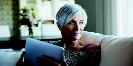 Elderly woman using a tablet.