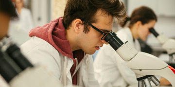 Man using a microscope.