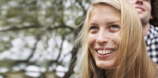 Blonde woman smiling.