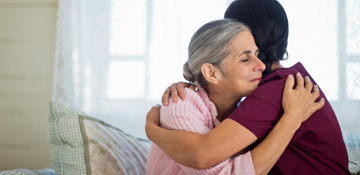 Nurse and patient hugging.