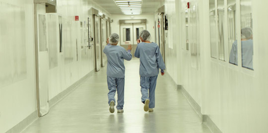 Nurses walking through corridor.