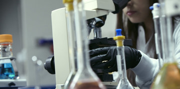 Scientist using a microscope.