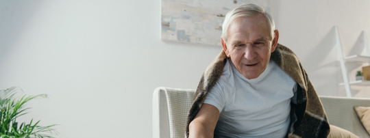 Elderly man grabbing some medicine.