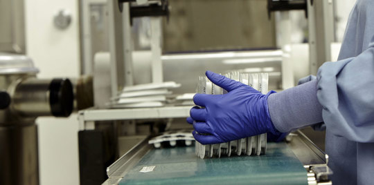 Factory worker packing medicine.