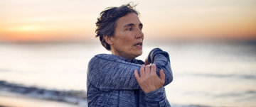 A woman stretching on the beach