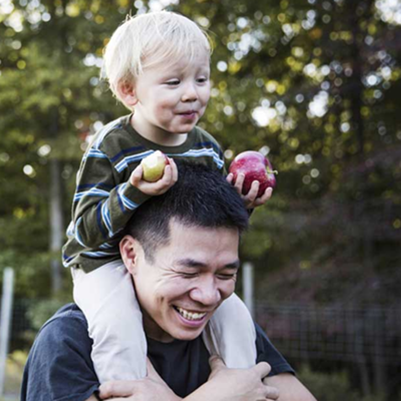 A father carrying his son on his shoulders