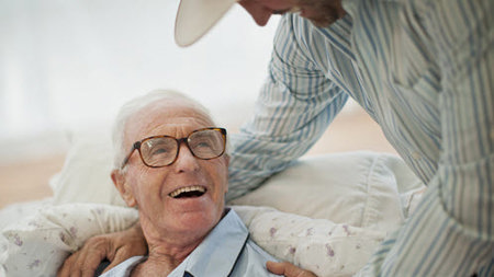 Man supporting and elderly patient.