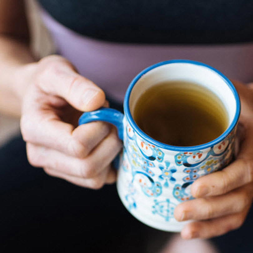 Woman holding a cup.