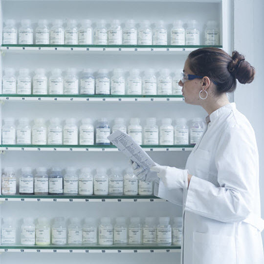 Woman looking at pills on shelves