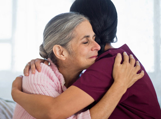Nurse hugging patient