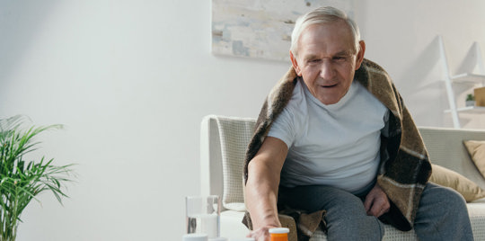 Elderly man reaching for something