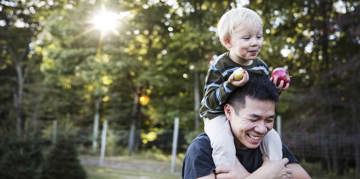 Father carrying his son on his shoulders