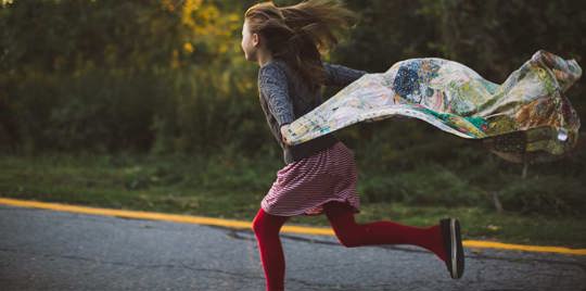 Girl running on the road.