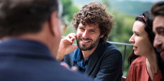 Man smiling with his friends.