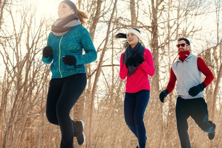 Three people jogging in a forest